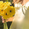 Women holding daisy flowers in the LuLu set